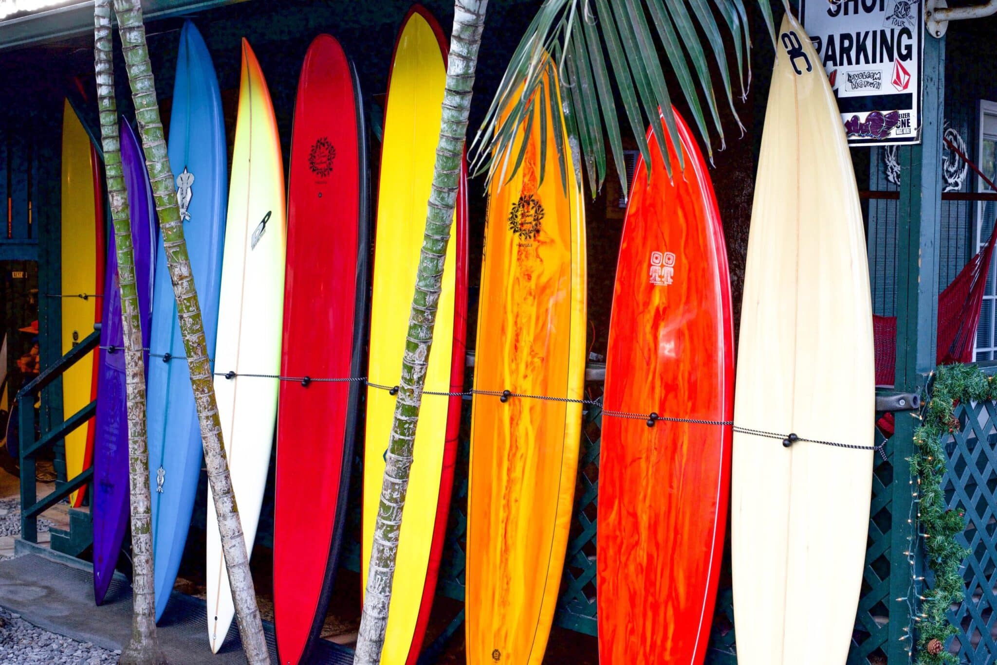 a group of people standing on top of a surfboard